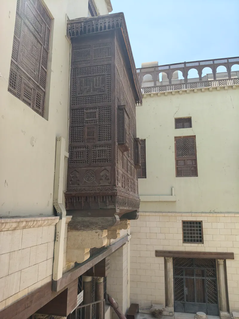 Wooden balcony and mashrabiya-style detail along an Old Cairo lane
