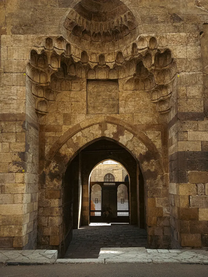 Carved stone gateway opening into a Historic Cairo street