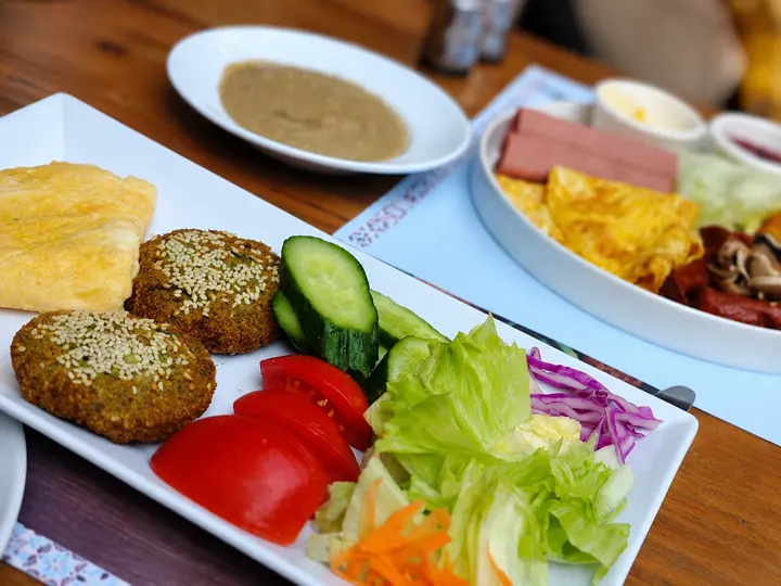 Shared Egyptian dishes on a wooden restaurant table